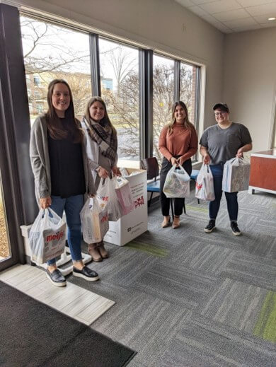 Members of Baker Hill's outreach team with bags of toys for Toys for Tots.